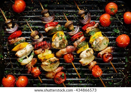Grilled vegetable and meat skewers in a herb marinade on a grill pan, top view Royalty-Free Stock Photo #434866573