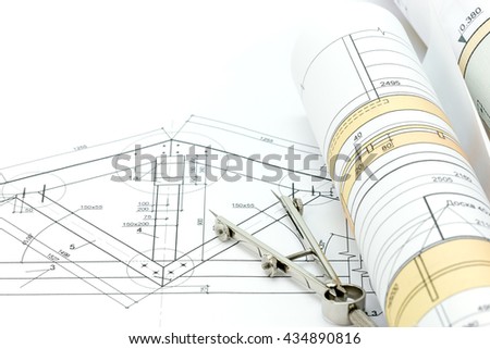 architectural blueprint rolls with plan and drawing compass