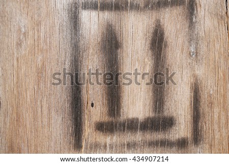 Black fragile symbol on wood