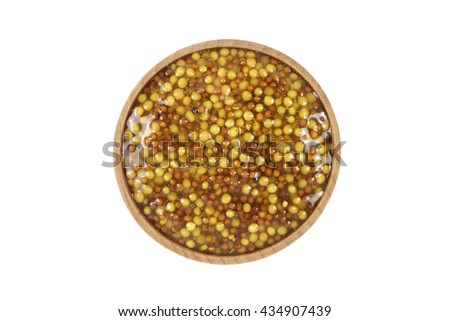 Preserved grain mustard in a wooden bowl on a white background