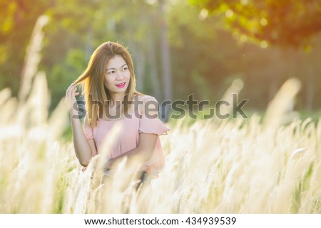 Woman walking in a field of grass. , Portrait Photography woman Thailand