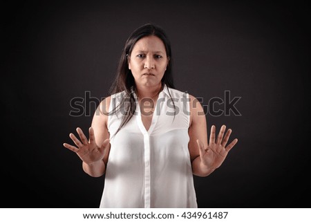 Beautiful woman doing different expressions in different sets of clothes: stop sign