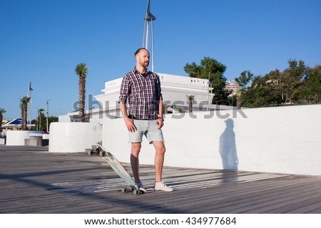 Man with longboard , summer city beach background