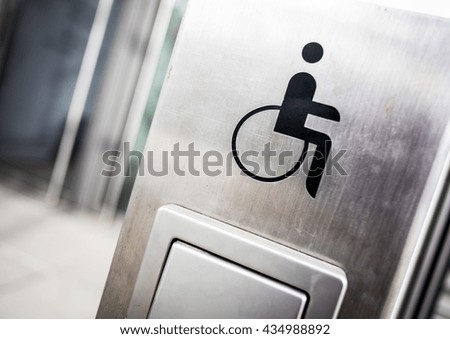 disabled sign at a door opener