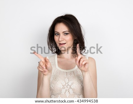 beautiful young brunette woman in a lace dress posing and expresses different emotions. girl's hands shows various signs. close-up portret