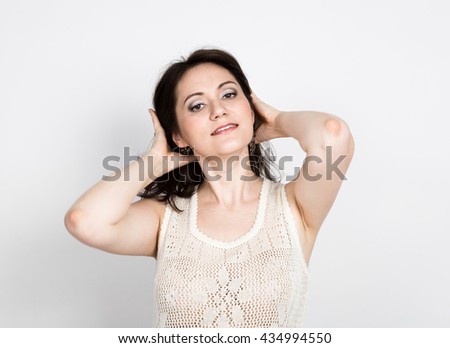 beautiful young brunette woman in a lace dress posing and expresses different emotions. girl's hands shows various signs. close-up portret