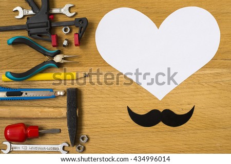 Happy fathers day sticker, tools, black paper mustache on wooden background