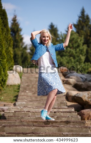 Portrait of beautiful girl posing in the Park fashion style skirt jacket