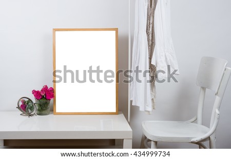 Empty wooden picture frame on the table, art print mock-up