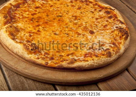 Pizza Margarita with wooden background