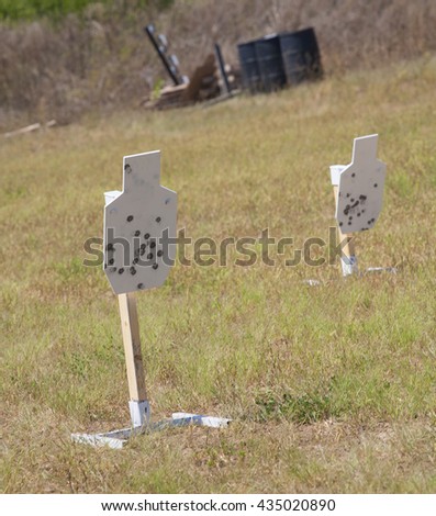 Pair of steel targets painted white that are used for firearm practice Royalty-Free Stock Photo #435020890