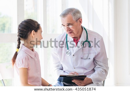Pediatrician doctor examining child