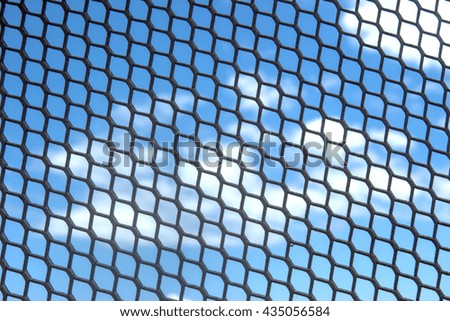 metal net with blue sky background