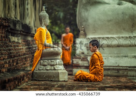 Novices monk vipassana meditation at front of Buddha statue Royalty-Free Stock Photo #435066739