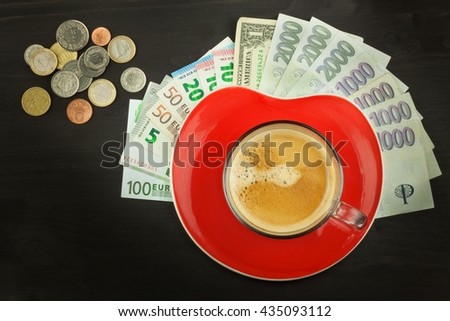 Global trade coffee. Cup of coffee and money. Valid banknotes on a wooden table. The problem of corruption. Trading in roasted coffee. Investing in the coffee trade.