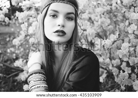Beautiful bohemian girl in spring garden. Black and white photo of woman. Monochrome colors