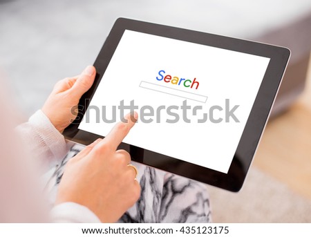 Person searching the internet on tablet computer