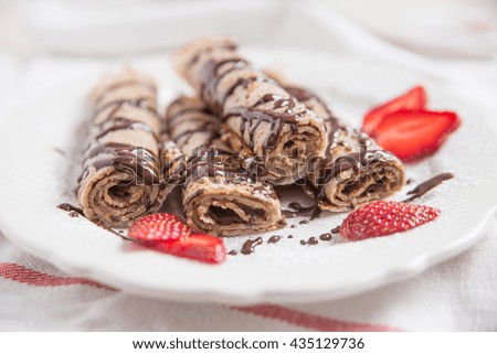 Traditional crepes with strawberries and chocolate cream