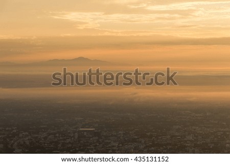 Birds eye view of city of Chiang Mai with buildings  , mountain on the background in the morning
