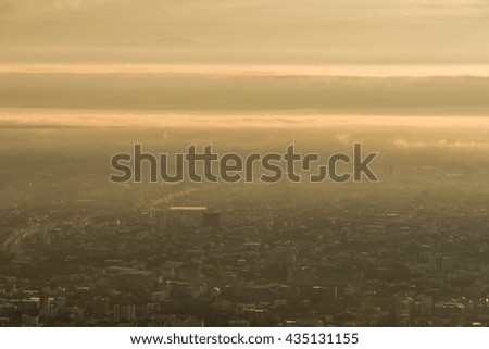 Birds eye view of city of Chiang Mai with buildings  , mountain on the background in the morning