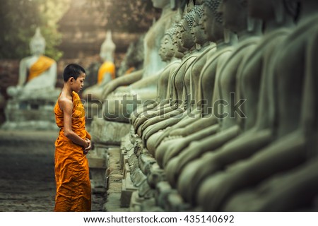 Novices monk vipassana meditation at front of Buddha statue Royalty-Free Stock Photo #435140692