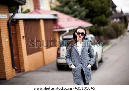 Professional saleswoman, people concept - happy businesswoman with blue folder over car background