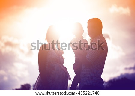 family, silhouette, three people in the evening light.