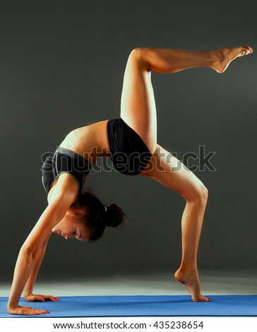Portrait of sport girl doing yoga stretching exercise
