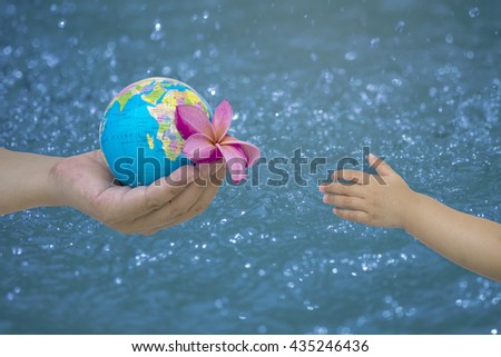 hand male gesture holding the worldon on blurred cyan turquoise blue wavy water background, human hands with healthy world concept, love and safe conception.