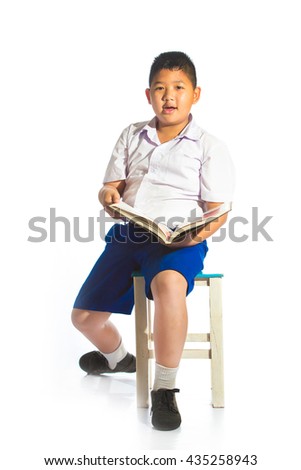 Thailand schoolgirl in uniform reading books on a white background.