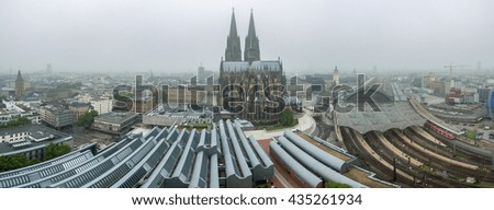 Aerial shot of Kolner/Cologne Dom/Cathedral with the Koln central station from above in the foggy day
