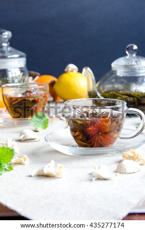 two cups oolong tea glass with fruit and glass kettle