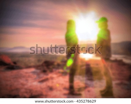 Abstract Blurred and soft photo of the lover standing on the hilltop during sunrise.