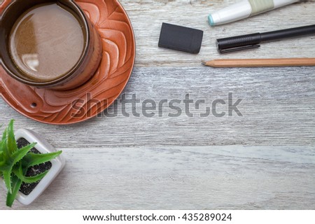 pen,pencil and coffee on wooden background