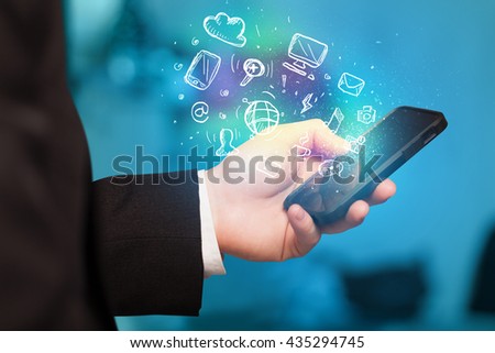 Hand holding smartphone with glowing multimedia icons 