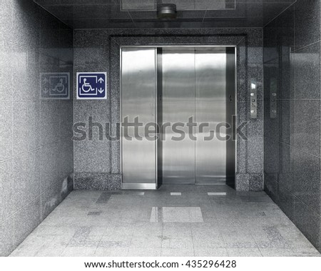 Accessible Elevator with sign and marble structure aisle, nobody