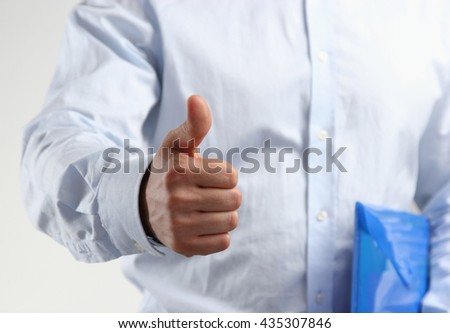 Close up of business man hand with thumb up.
