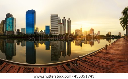 Business district cityscape from a park with sunrise time from Benchakitti  park, Bangkok Thailand