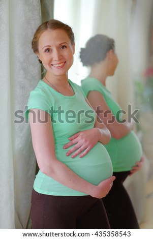 pregnant woman caressing her belly 