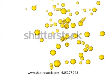 Yellow oil bubbles over a white background