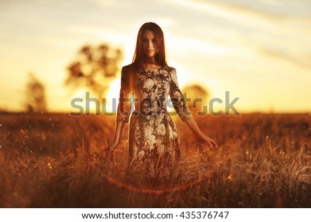 girl in the sunset cloudy sky Field