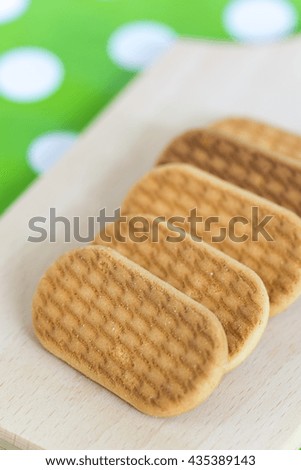 Biscuits in the row on the wooden board