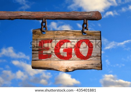 Ego motivational phrase sign on old wood with blurred background