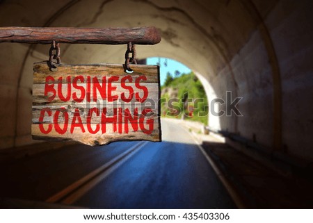 business coaching motivational phrase sign on old wood with blurred background
