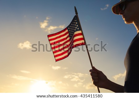 Girl holding USA flag.