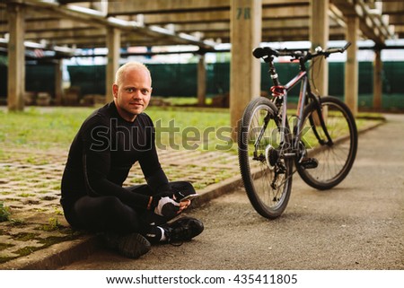 bicycle man with smartphone on parking