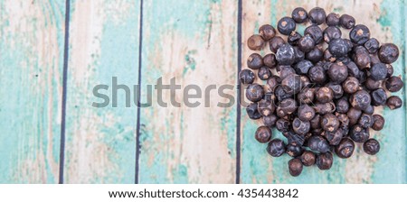 Juniper berries over wooden background