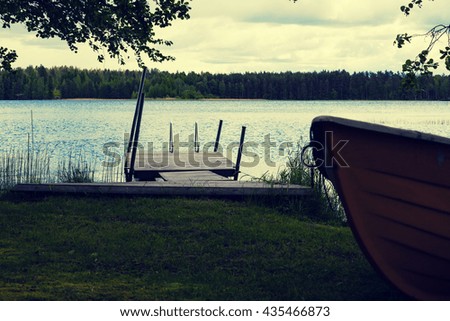 Summer landscape with lake and boat