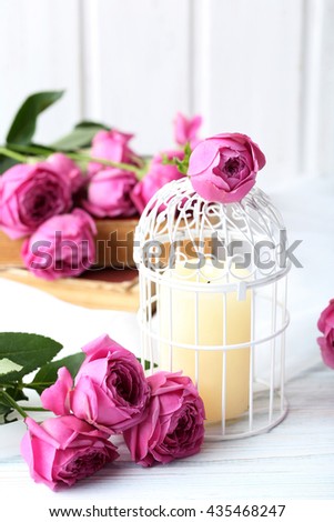 Beautiful pink roses on a white wooden table