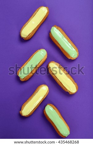Eclairs with glaze on a paper background
